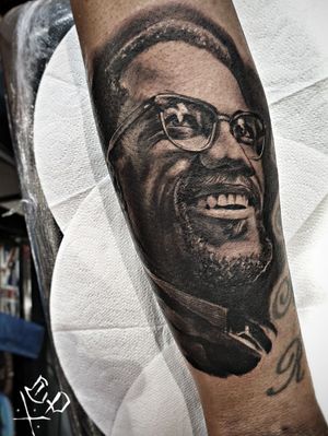 Detailed blackwork tattoo of a man with a beard by Mauro Imperatori, perfect for forearm placement.