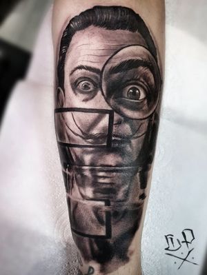 Mauro Imperatori's black and gray forearm tattoo featuring a realistic Salvador Dali inspired design with a magnifying glass motif.