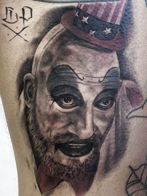 Get a chillingly realistic tattoo of Clown & Captain Spaulding by Mauro Imperatori on your arm. A tribute to horror enthusiasts!