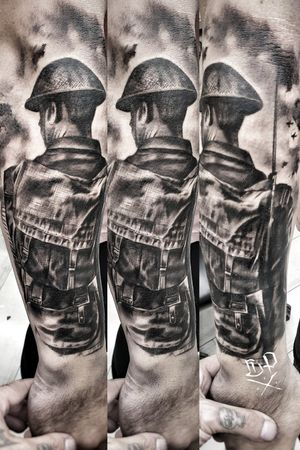 Get inked by Mauro Imperatori with this detailed black and gray forearm tattoo featuring a soldier wearing a helmet in stunning realism style.