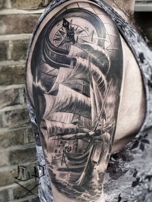Get inked by Mauro Imperatori with this detailed compass and ship design, perfect for your upper arm. Symbolizing direction and adventure.