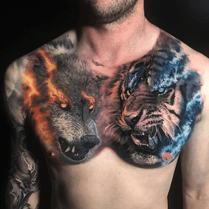 Wolf on left pec, not a tiger but a lion on right pec with the same fire