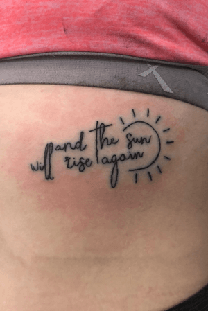 Her first tattoo done on the rib area “and the sun will rise again ☀️”