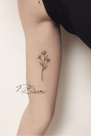Beautiful and delicate flower and sprig design by tattoo artist Patrick Bates. Perfect for those looking for a minimalistic yet elegant tattoo.