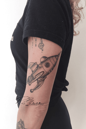 Get ready to blast off with this detailed blackwork rocket tattoo by Patrick Bates. Perfect for space enthusiasts!