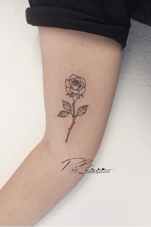 Get a beautifully detailed flower tattoo on your upper arm with intricate fine line work by talented artist Patrick Bates.