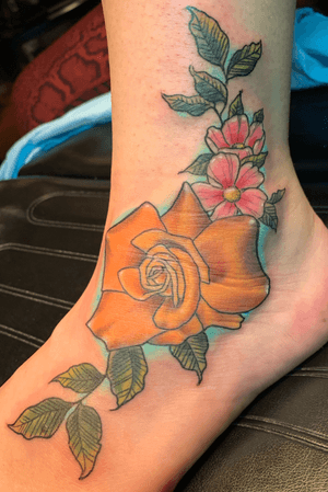 Color rose tattoo on foot ankle area 