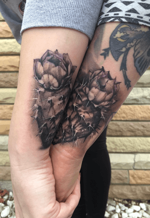 Two Cactus Sister tattoos that form a heart when they hold hands.  