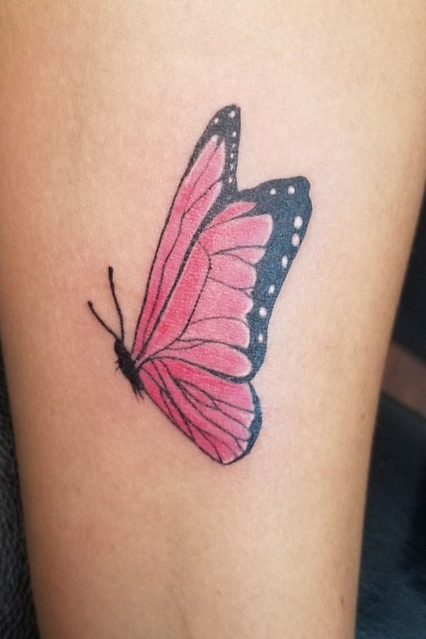 Watercolor pink butterfly tattoo on the shoulder