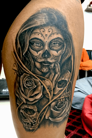 Chicano girl face tattoo on dark skin.