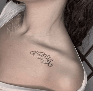 Get a small lettering tattoo of your name on your shoulder, expertly done by Alejandro Gonzalez.
