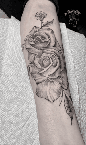 Beautiful black and gray floral design featuring roses, created by Alejandro Gonzalez on the forearm.