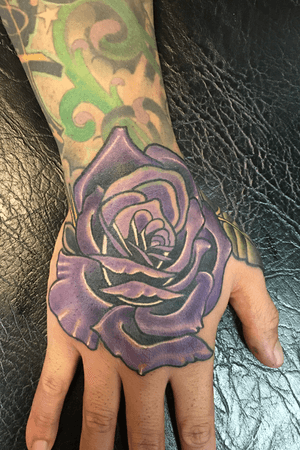 Purple rose on the hand 