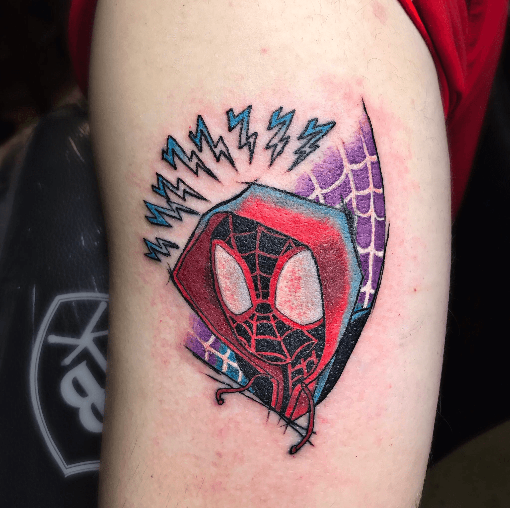 Miles Morales tattoo located on the thigh
