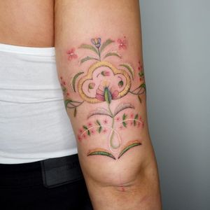 Get a unique illustrative tattoo of a beautiful flower in patchwork style, designed by Adi D for your upper arm.