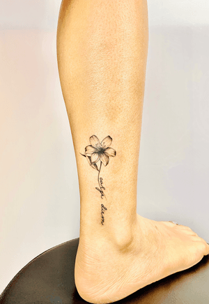 woman's ankle flower and lettering