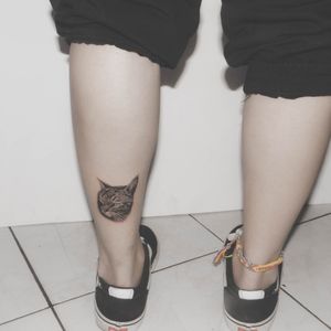 Cat tattoo near the ankle 