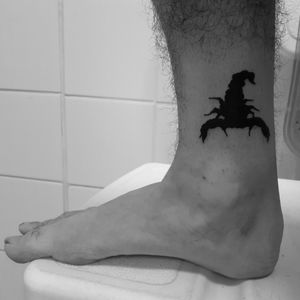 Black work scorpion flash tattoo on lower leg 
