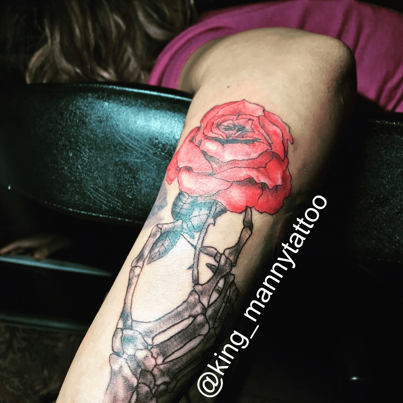 Hand holding rose tattoo by Luc 