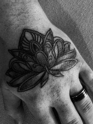 Lotus Flower to match my wife's lotus flower on her chest. Decided to get this in place of a ring tattoo.