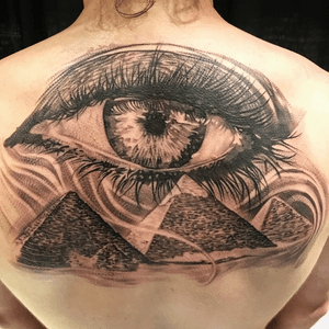Discover the ancient secrets with this black and gray illustrative tattoo on your upper back, by Jake Masri.