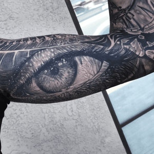 Adorn your upper arm with a striking blackwork illustrative eye tattoo, expertly crafted by tattoo artist Jake Masri.