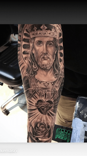 Experience the realistic beauty of sacred heart of Jesus in this stunning black and gray tattoo by accomplished artist Jake Masri.