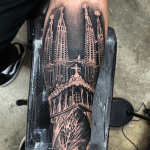 Get a stunning blackwork tattoo of a cross and church on your forearm by the talented artist Jake Masri.