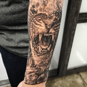 Capture the raw power and beauty of a lion with this stunning black and gray realism tattoo by Jake Masri.