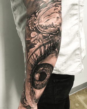 A captivating black and gray eye tattoo on the forearm, expertly done by tattoo artist Jake Masri. Show off your unique style with this stunning design.