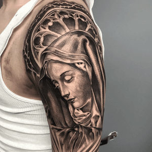 Unique black and gray tattoo of a nun on the upper arm, beautifully rendered by artist Jake Masri.