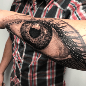 Get a stunning black and gray eye tattoo on your forearm by the talented artist Jake Masri, for a truly eye-catching look.