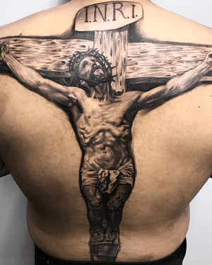 Adorn your upper back with a stunning black and gray portrayal of Jesus wearing the crown of thorns. By renowned artist Jake Masri.