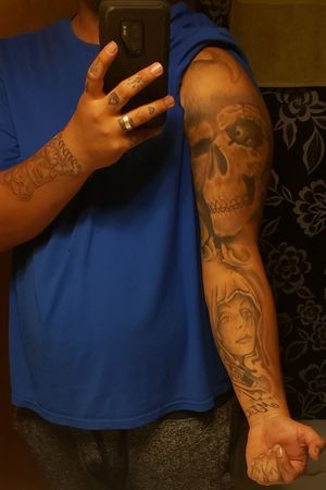 Tattoosbysaints Or SinninSaints (The skull is a cover up it used to be an outline of Louisiana but now its half a sleeve of a skull both the skull and gypsy are not finished yet but they are fucking RAD !!! ) Follow my artist on Instagram and book your appointment tell him Turtle or StaticSins sent you !! 