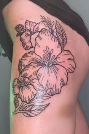 Flower design done top of thigh.