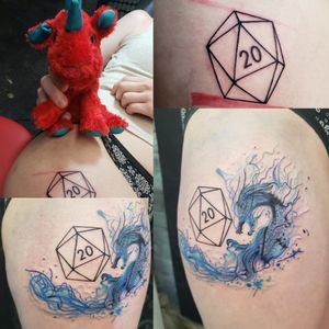 20 sided die with watercolor dragon, while holding our comfort animal, Charles.
