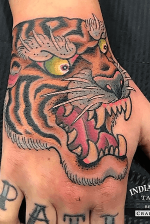 Traditional tiger hand tattoo by Craig Kelly
