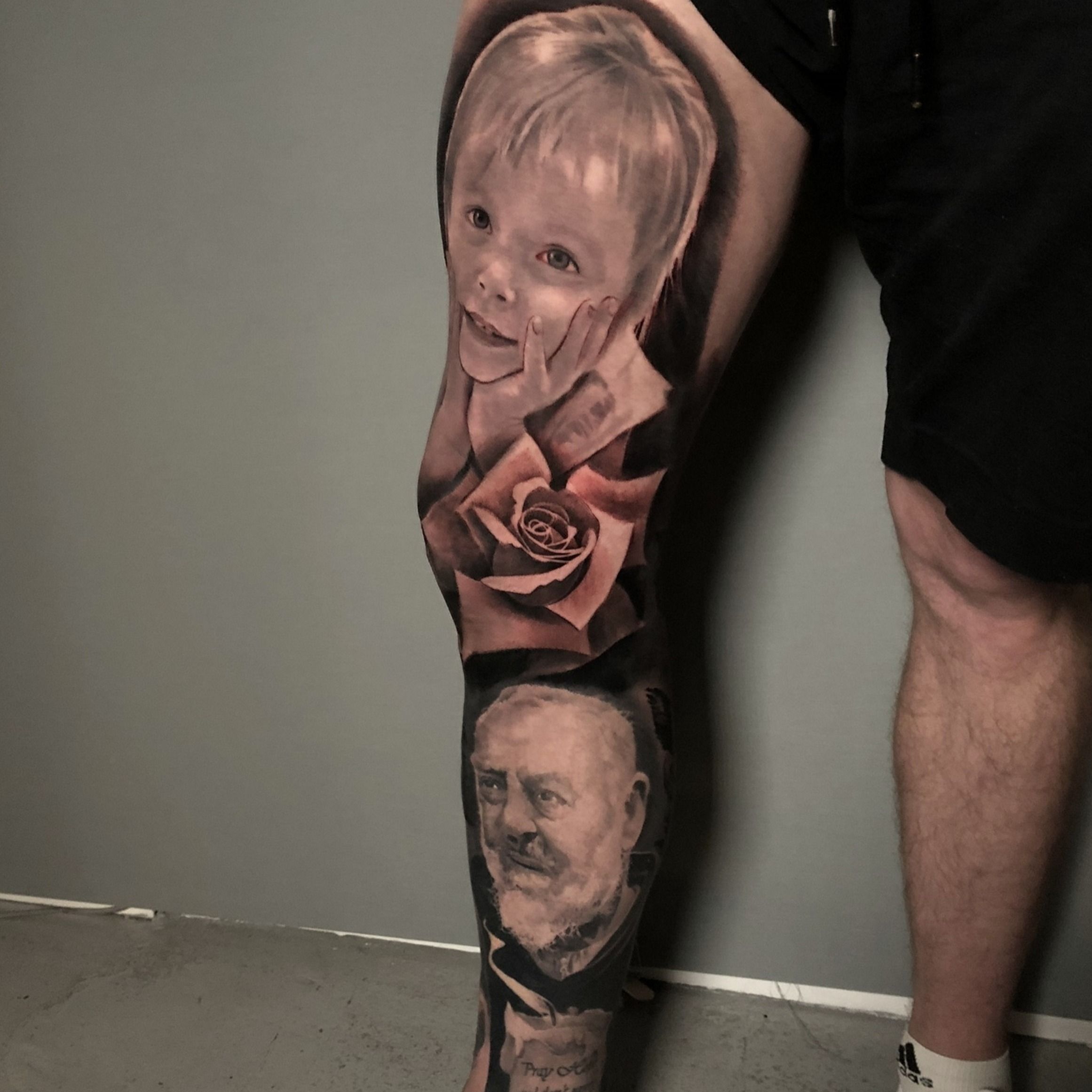 Calf leg portrait tattoo in black and grey realism by Alo Loco