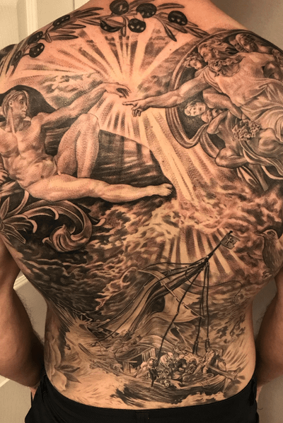 A stunning black and gray upper back tattoo featuring a ship and a bearded man, created by the talented artist Jake Masri.