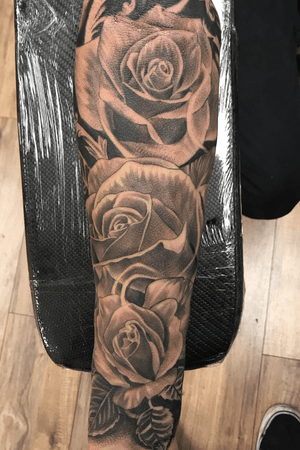 Stunning black flower forearm tattoo combining black_and_gray and blackwork styles by talented artist Jake Masri.