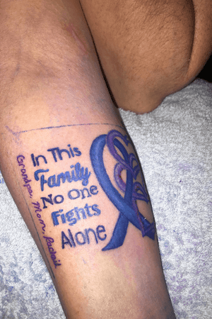 Memorial tattoo with quote, blue ribbon, and three heart pendants 