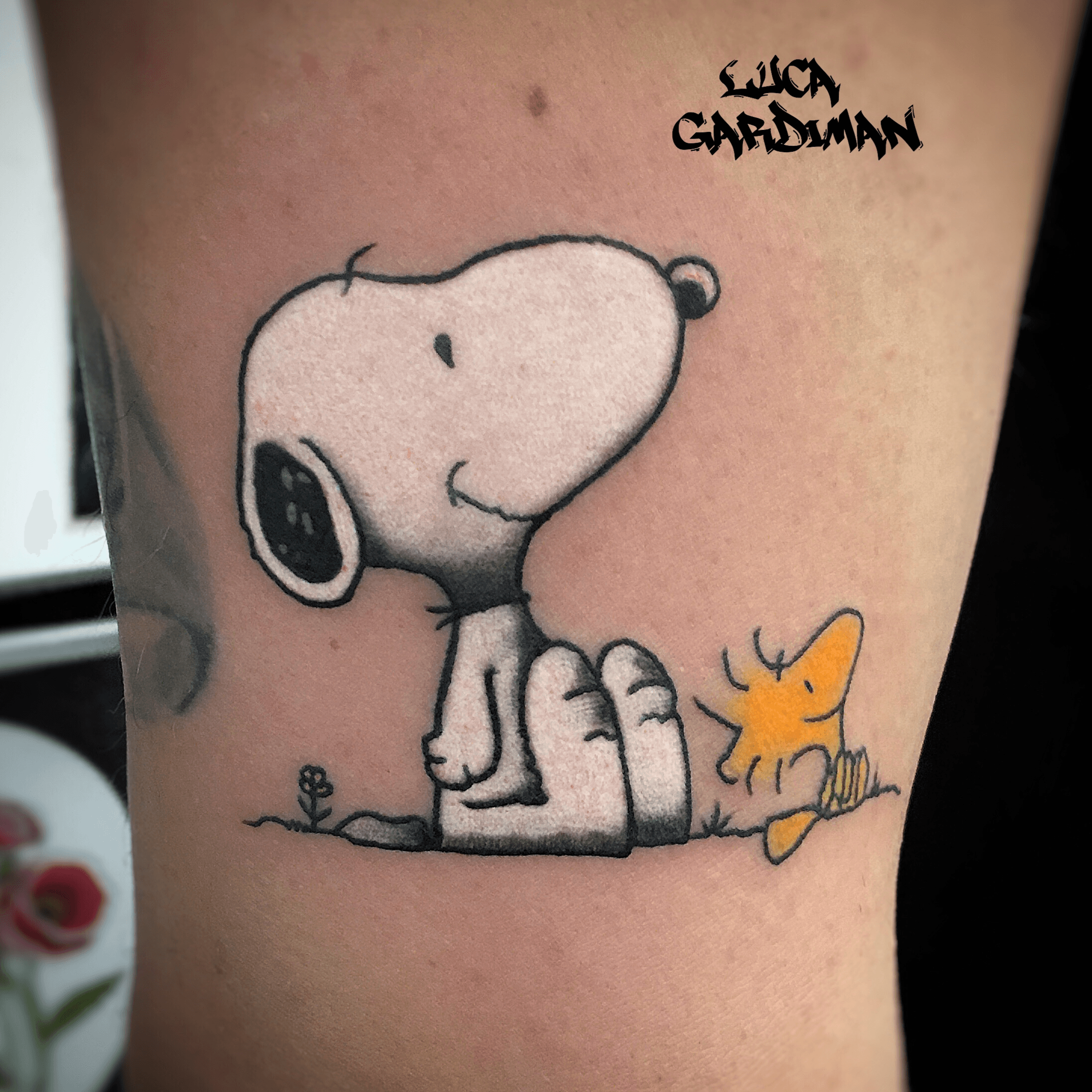 Snoopy and woodstock hugging each other tattoo on the