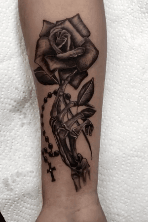 Skeleton hand holding a rose 