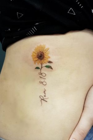 Sunflower and script on the ribs. 