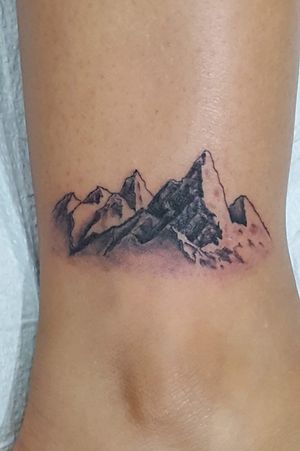 Micro tattoo of a mountain view.