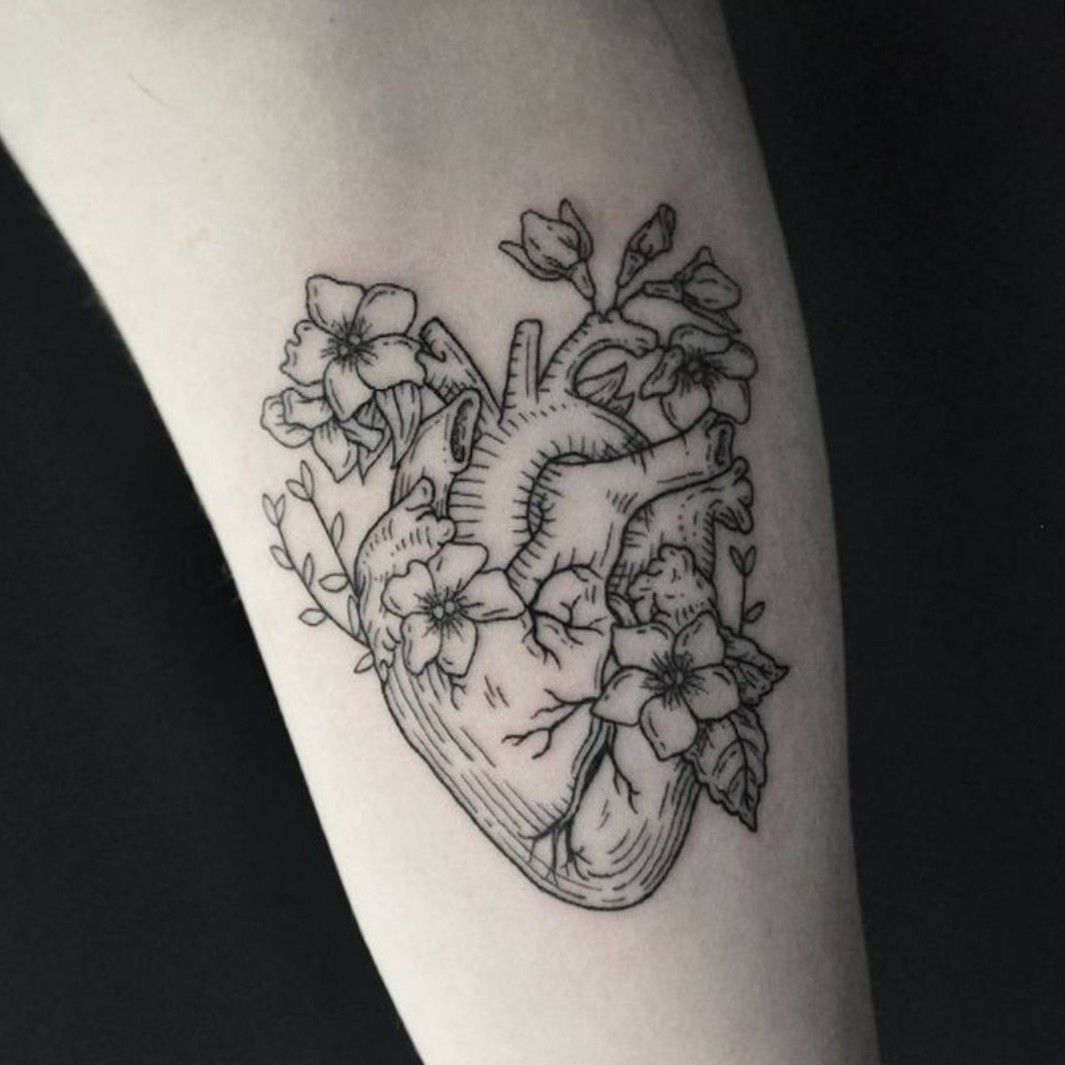 Flower heart tattoo placed on the ankle fine line