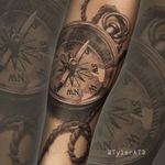 Black and grey realistic compass and rope forearm tattoo