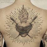 Blackwork sacred heart with swords and palms back tattoo.