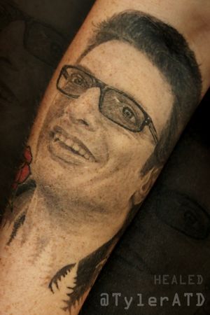 Realistic black and grey Jeff Goldblum portrait tattoo. healed