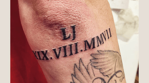 Some Roman numerals on the arm and elbow. 
